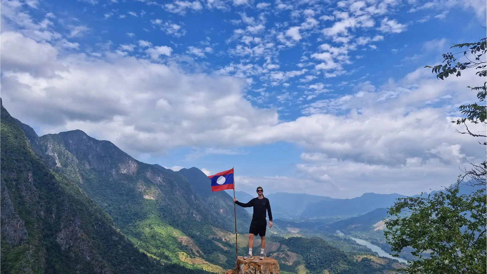 on top of pha daeng viewpoint nong kiaw with lao flag