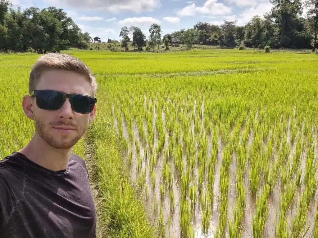 living in laos as a foreigner in a rural village selfie with rice farms