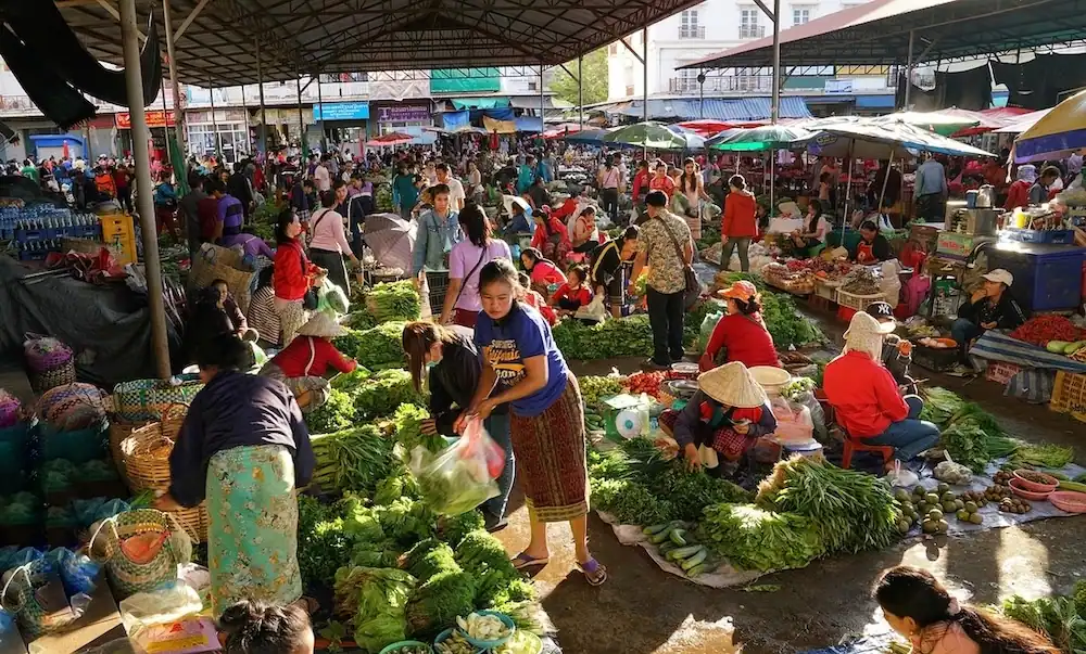 typical market in laos, where foreigners living in laos can buy cheap food