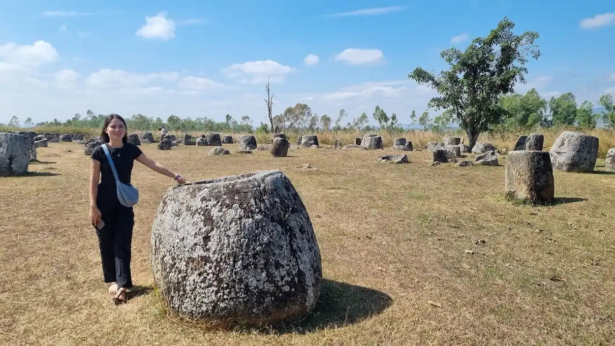 plain of jars site 1 local girl standing next to a jar
